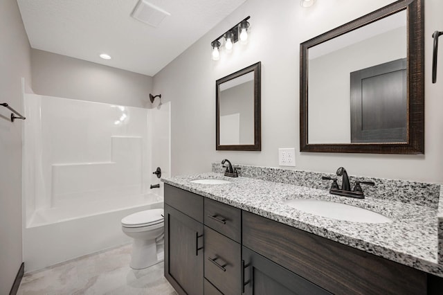 bathroom with  shower combination, a sink, toilet, and double vanity