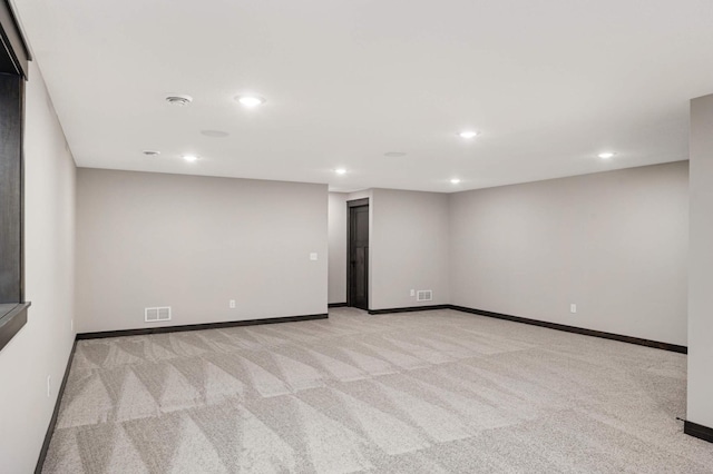 unfurnished room featuring recessed lighting, visible vents, light carpet, and baseboards