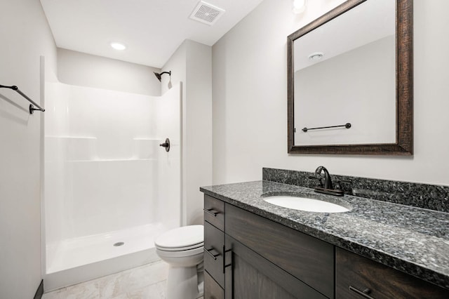 bathroom with a stall shower, visible vents, vanity, and toilet