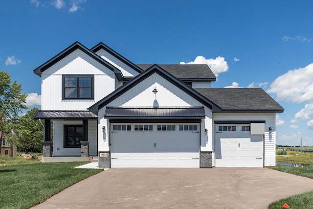 view of front of house with a front yard and a garage