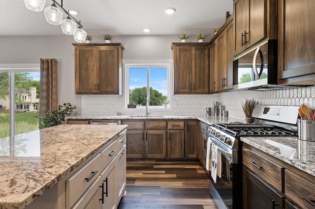 kitchen with a wealth of natural light, sink, and appliances with stainless steel finishes