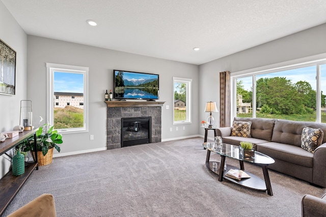 living room featuring carpet flooring, a stone fireplace, and a textured ceiling