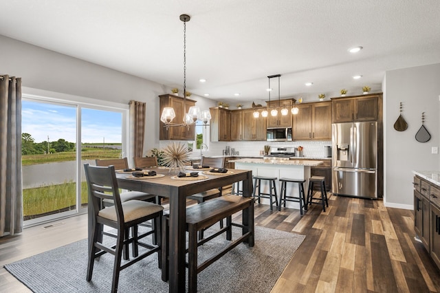 dining area featuring a notable chandelier and dark hardwood / wood-style floors