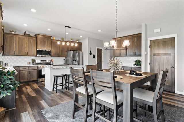 dining room featuring an inviting chandelier and dark wood-type flooring