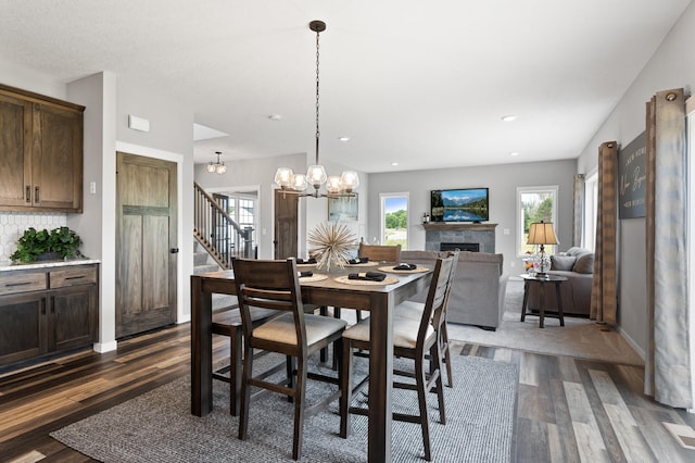 dining room featuring dark hardwood / wood-style floors and an inviting chandelier