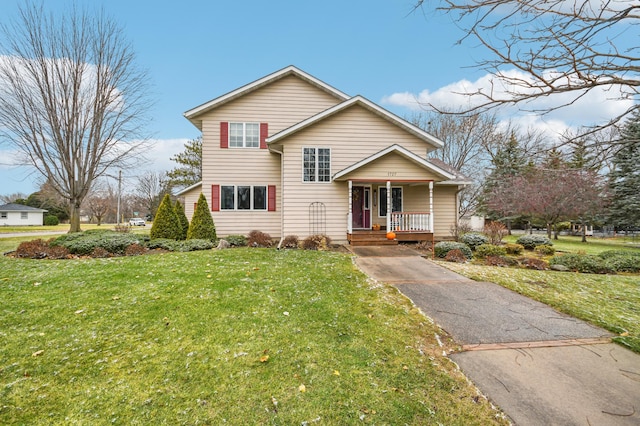 front of property featuring covered porch and a front lawn