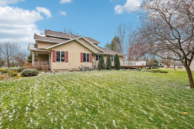 view of property exterior with central air condition unit, a deck, and a lawn