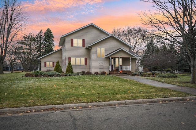 view of front of property featuring a lawn and covered porch