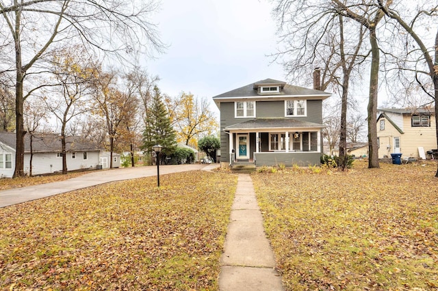 view of property featuring covered porch