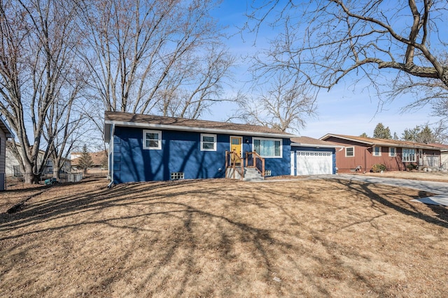 ranch-style house with an attached garage, driveway, and a front yard