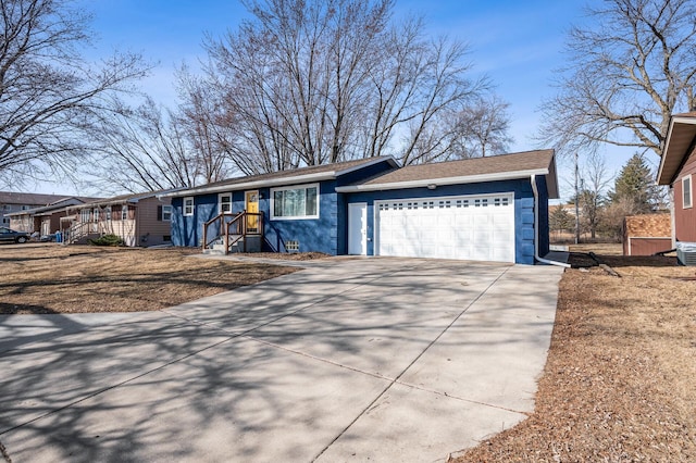 ranch-style house with crawl space, a garage, roof with shingles, and driveway