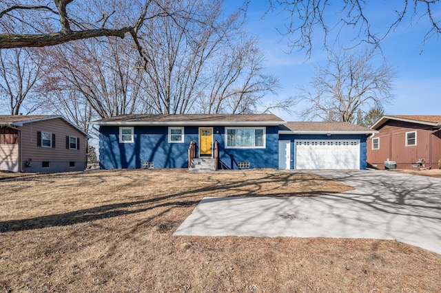 view of front of property with driveway, a front lawn, and a garage