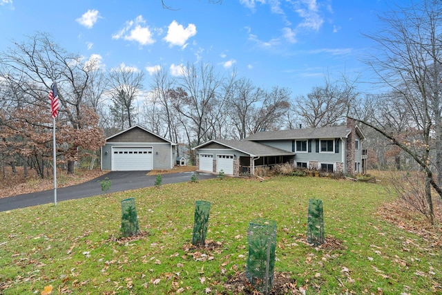 view of front of home with a front lawn and a garage