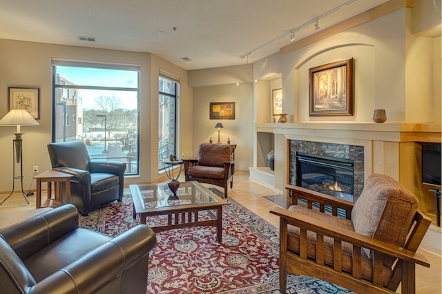 sitting room featuring track lighting and a premium fireplace