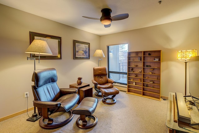 sitting room featuring ceiling fan and carpet floors