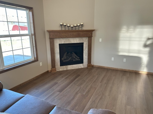 unfurnished living room with wood-type flooring and a fireplace