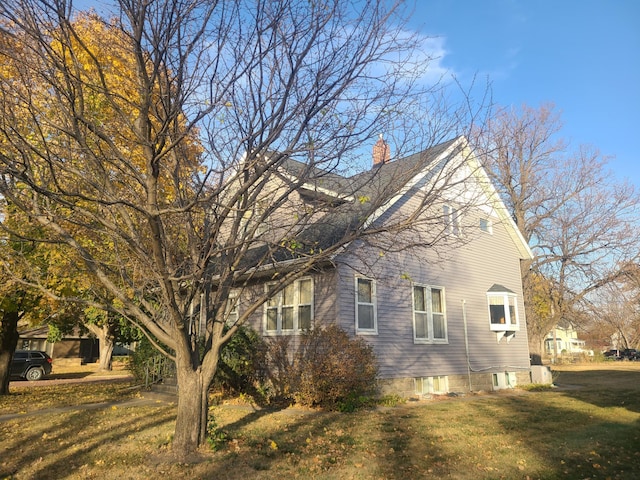 view of home's exterior with a yard