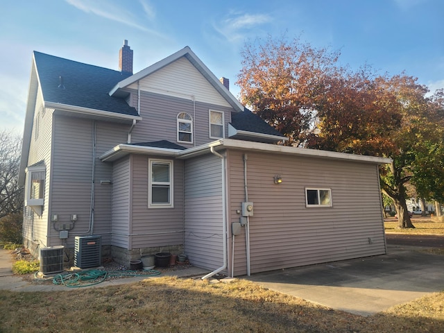 rear view of property featuring a patio area and central air condition unit