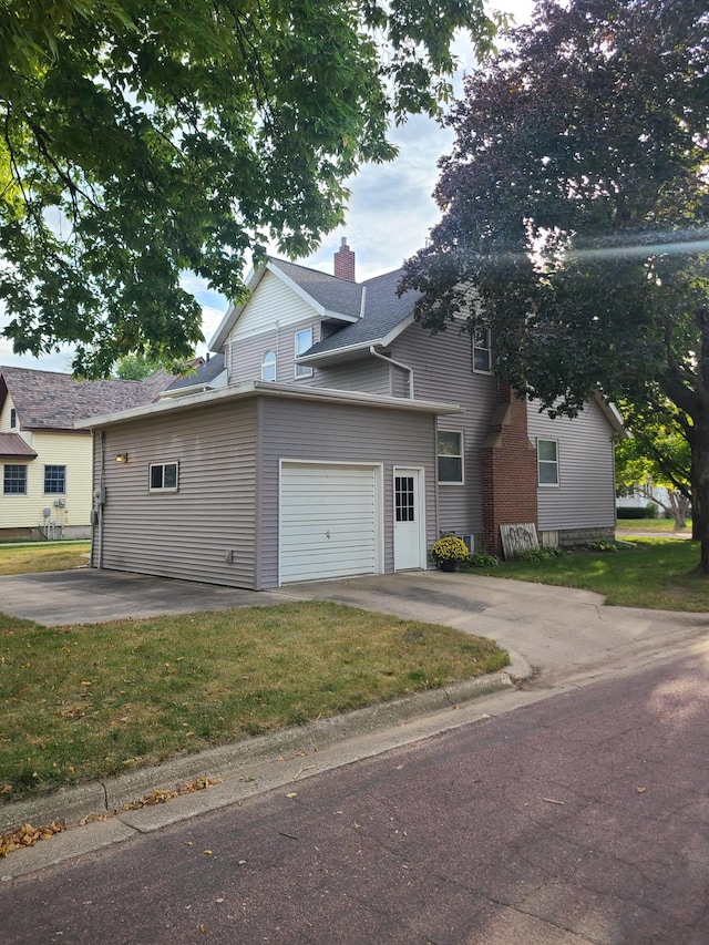 exterior space with a garage and a front yard