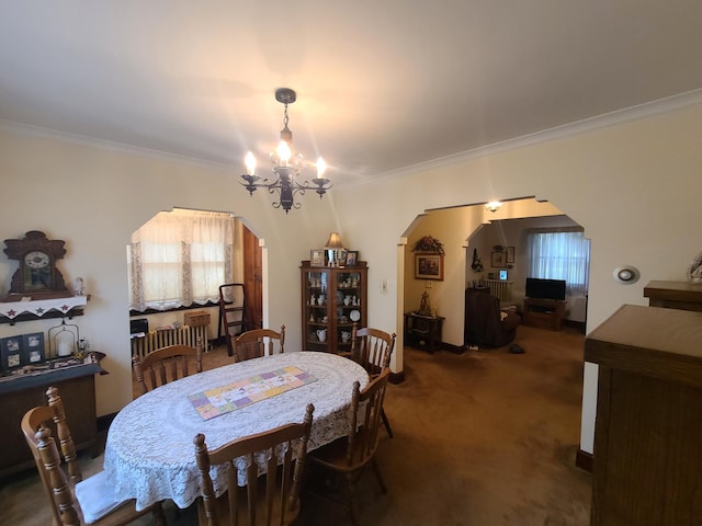 dining area with dark carpet, crown molding, and a notable chandelier