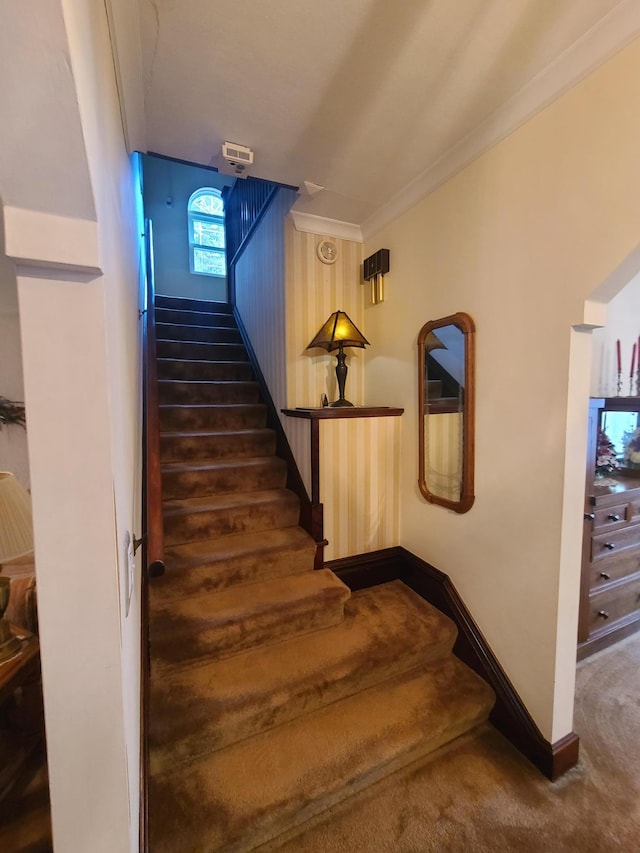 staircase with carpet flooring and ornamental molding