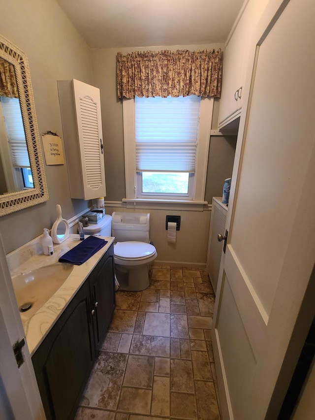 bathroom featuring vanity and toilet