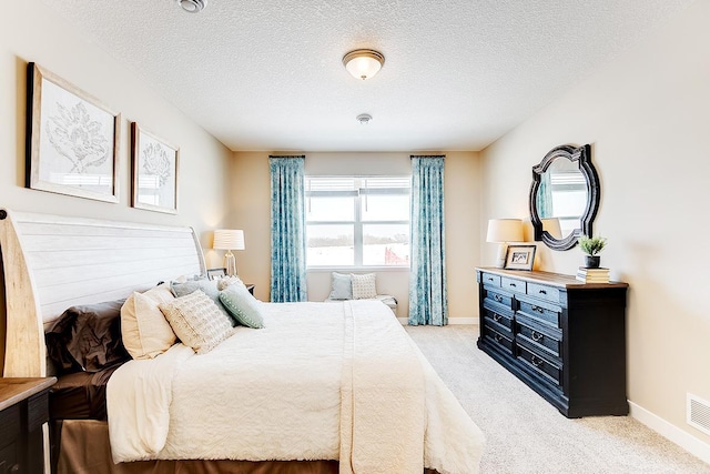 carpeted bedroom featuring a textured ceiling