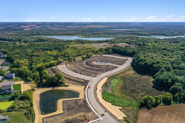 bird's eye view with a water view and a forest view