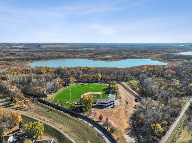 aerial view with a water view and a wooded view