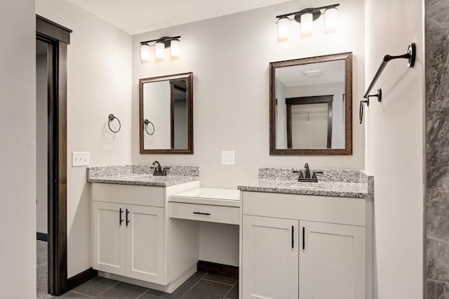 bathroom with two vanities, a sink, baseboards, and tile patterned floors