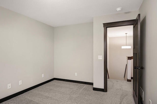 unfurnished bedroom featuring carpet floors, visible vents, and baseboards