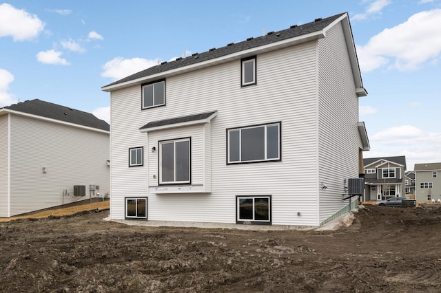 rear view of house with central AC unit