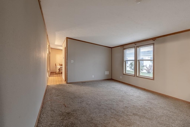 carpeted empty room with crown molding