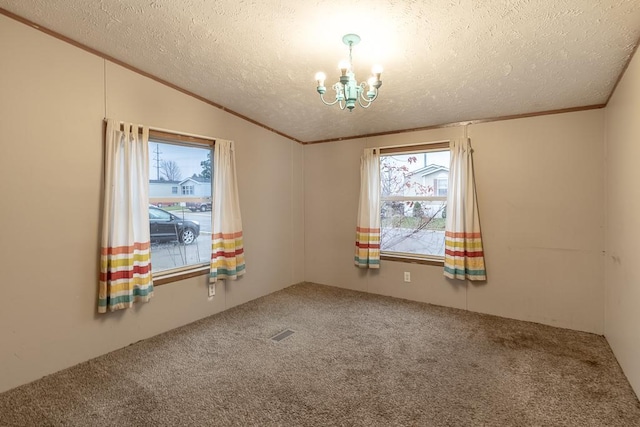 spare room featuring carpet flooring, lofted ceiling, a textured ceiling, and a notable chandelier