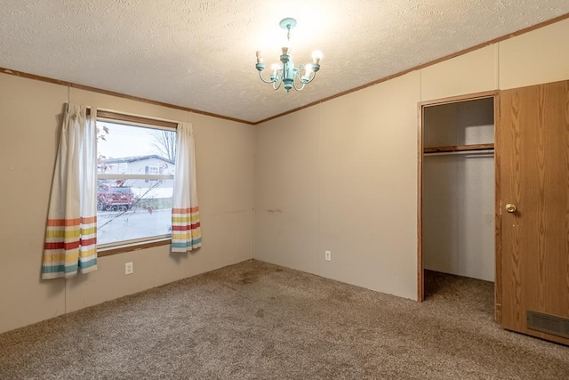 unfurnished bedroom with lofted ceiling, a closet, carpet floors, and a textured ceiling