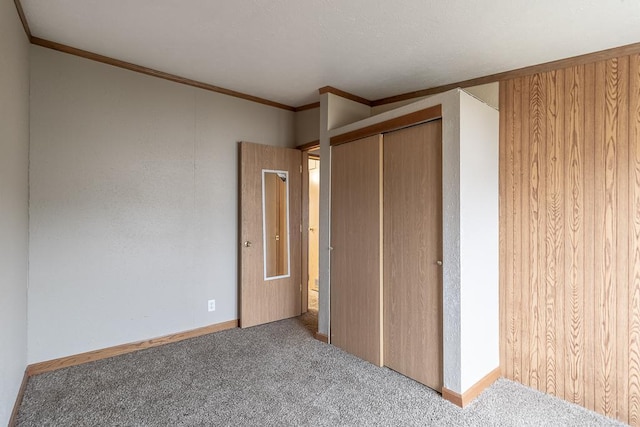 unfurnished bedroom featuring crown molding, a closet, and light colored carpet