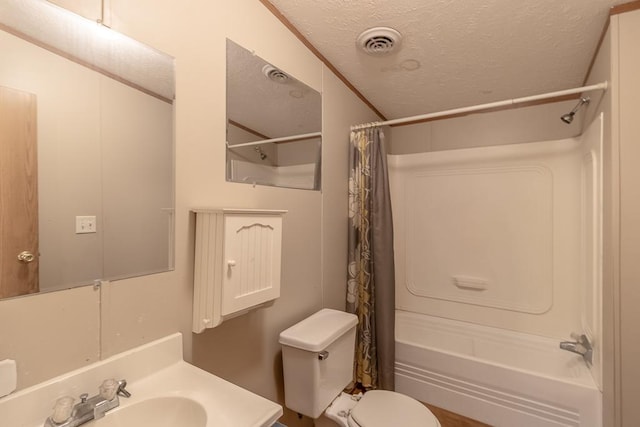 full bathroom with shower / tub combo, vanity, a textured ceiling, and toilet