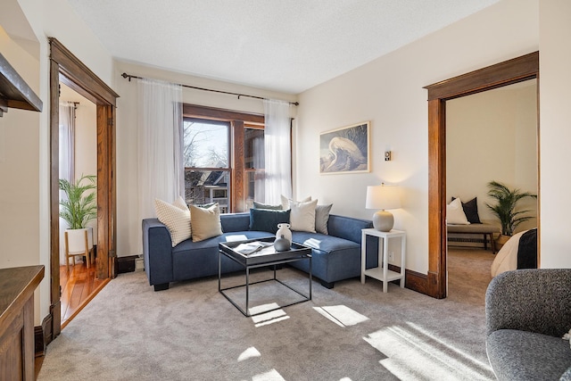 living room featuring light colored carpet and a textured ceiling