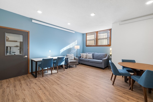 office area featuring a textured ceiling and light hardwood / wood-style flooring