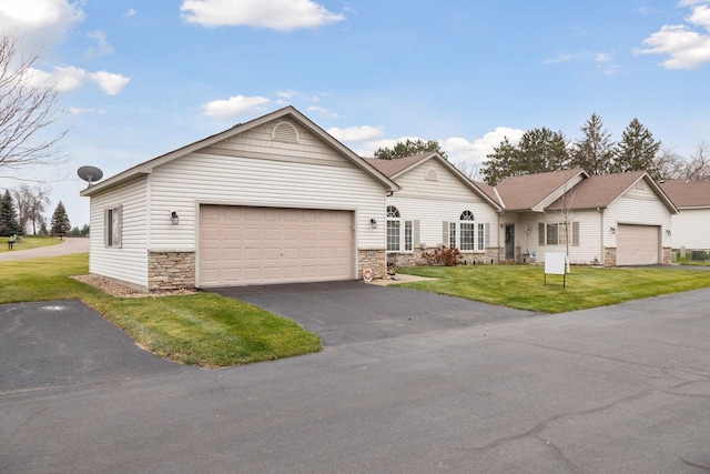 ranch-style home featuring a front yard and a garage