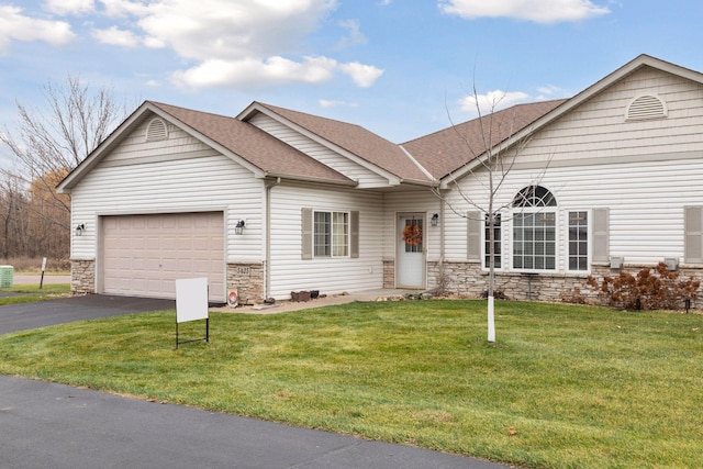 ranch-style home with a front yard and a garage