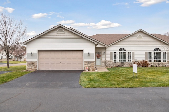 ranch-style home with a garage and a front lawn