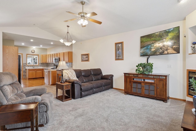 carpeted living room featuring ceiling fan and lofted ceiling