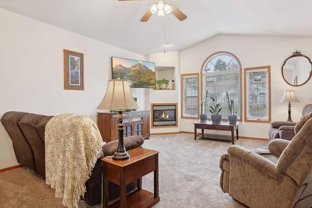 carpeted living room with ceiling fan and lofted ceiling