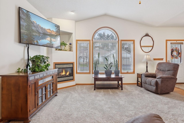 living area featuring carpet floors and vaulted ceiling