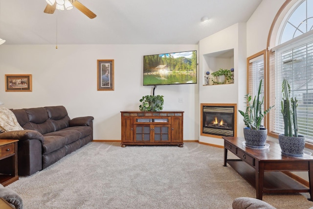 carpeted living room with plenty of natural light, lofted ceiling, and ceiling fan