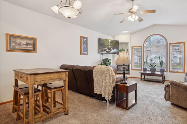 living room featuring light carpet, ceiling fan, and lofted ceiling