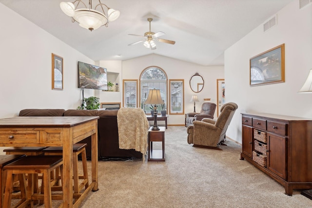 carpeted living room with vaulted ceiling and ceiling fan