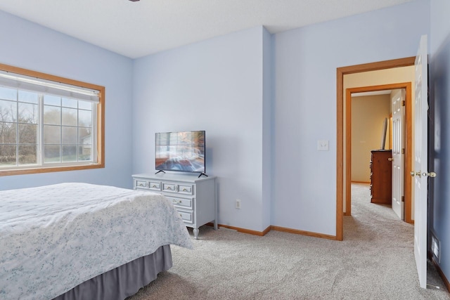 bedroom featuring light carpet