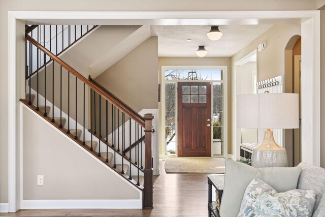 21360 Christmas Ln, Shorewood, MN 55331 - foyer with arched walkways, stairway, and wood finished floors